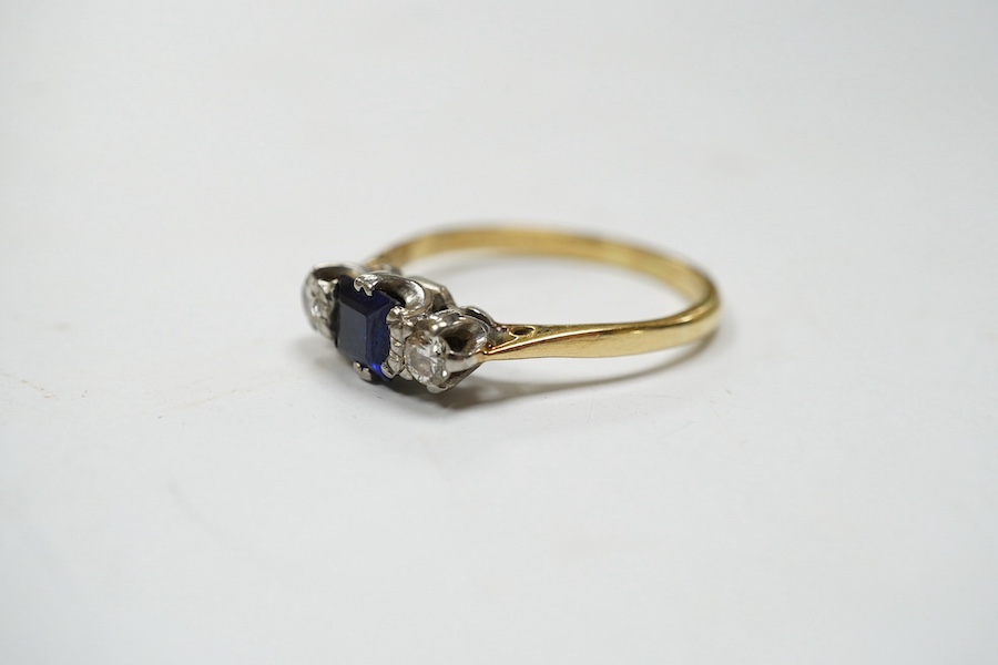 A yellow metal, sapphire and diamond set three stone ring, size Q, gross weight 3 grams. Condition - fair